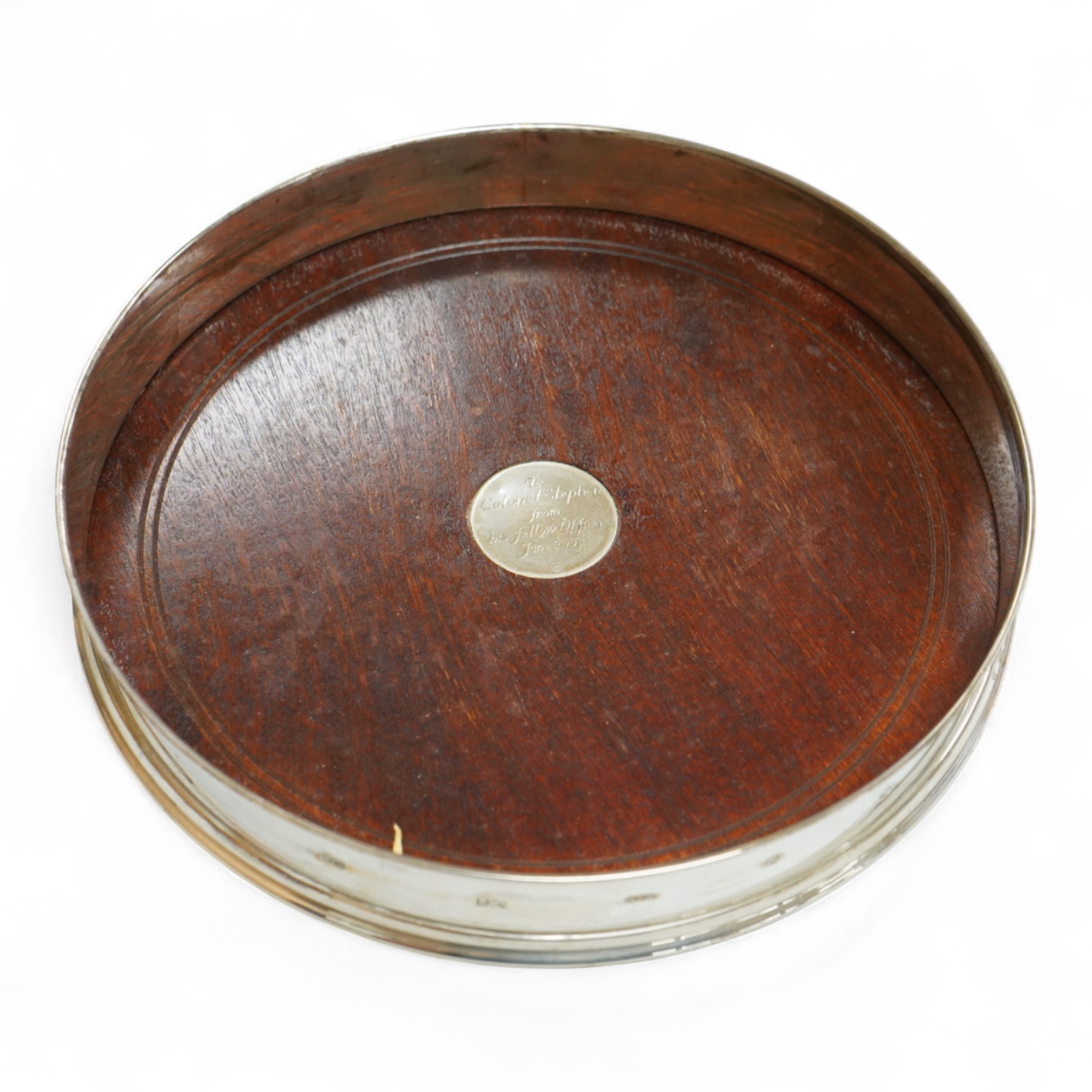 An Elizabeth II large silver mounted decanter coaster, maker W.E.V., London, 2000, with presentation inscription to central boss, diameter 25.6cm.